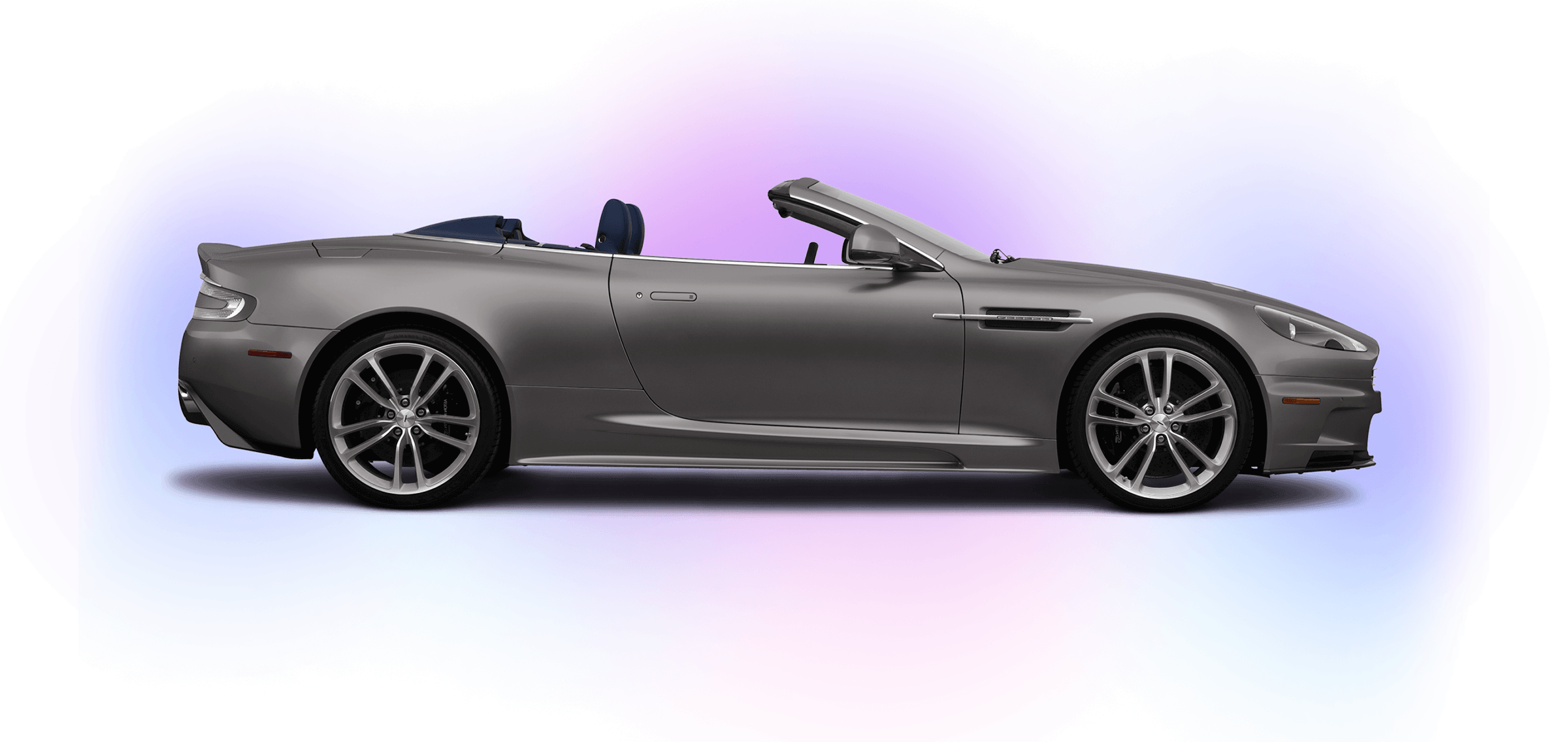 A side profile of a silver Aston Martin DBS Volante convertible car